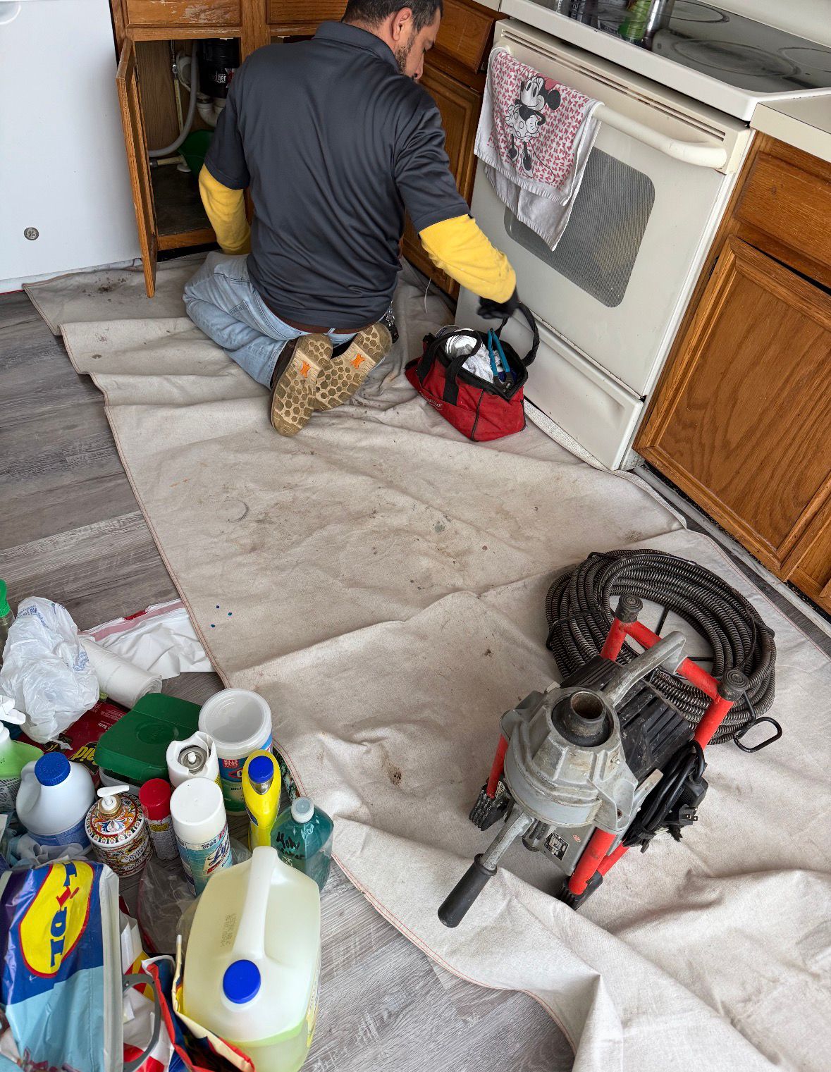 Wael performing drain cleaning